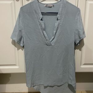 Womens medium blouse. V neck in front high low on one side. Light blue. Worn 1.